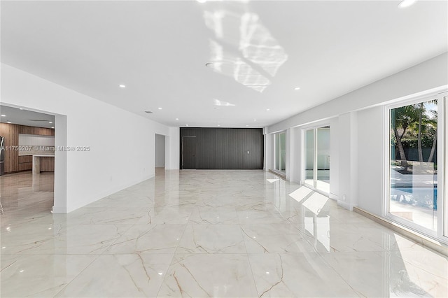 spare room with marble finish floor and recessed lighting