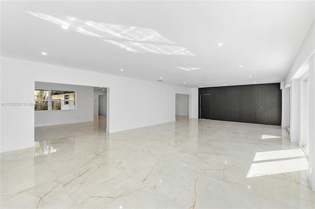 unfurnished room with marble finish floor and recessed lighting