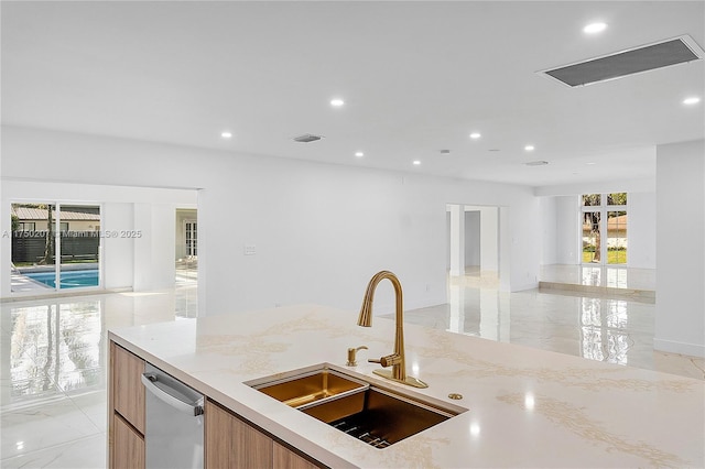 kitchen with open floor plan, a sink, marble finish floor, and stainless steel dishwasher