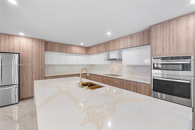 kitchen featuring stainless steel appliances, a sink, marble finish floor, wall chimney range hood, and modern cabinets