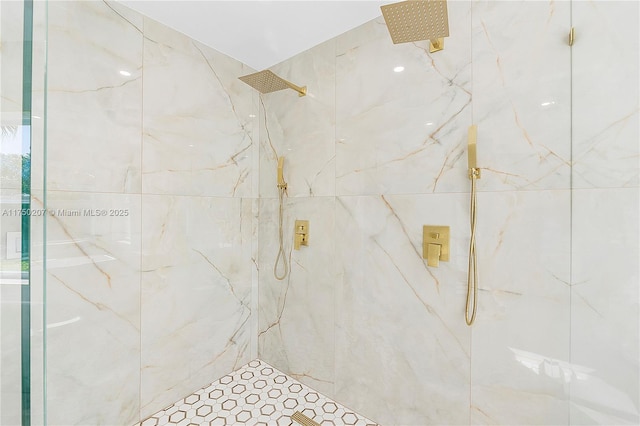 bathroom with a marble finish shower