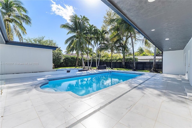 view of pool featuring a patio area, fence, and a fenced in pool