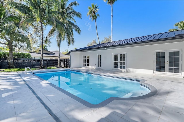 view of pool featuring a fenced in pool, french doors, a patio area, and fence