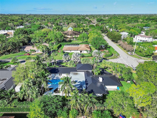 drone / aerial view with a wooded view