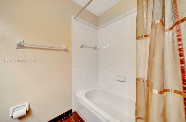 full bath featuring shower / tub combo and baseboards