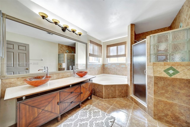 bathroom featuring double vanity, a sink, a shower stall, and a bath