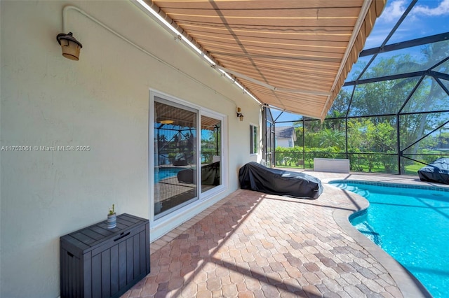 pool featuring a patio area and glass enclosure