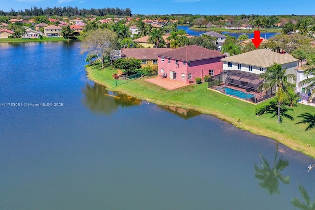 drone / aerial view featuring a water view and a residential view