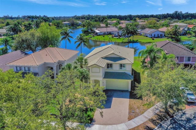 drone / aerial view featuring a water view and a residential view