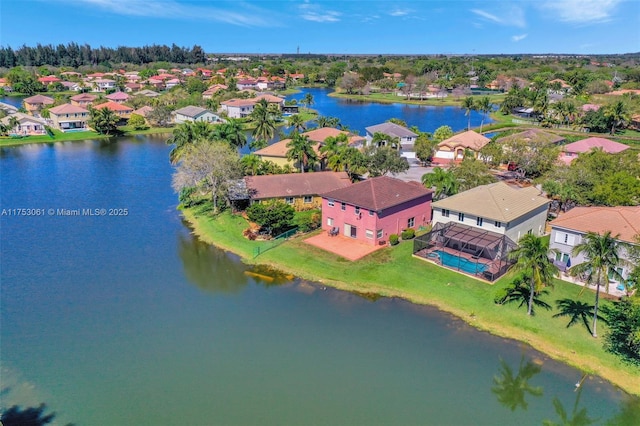 drone / aerial view with a residential view and a water view