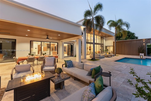 view of pool featuring a fenced in pool, a patio area, and an outdoor living space with a fire pit