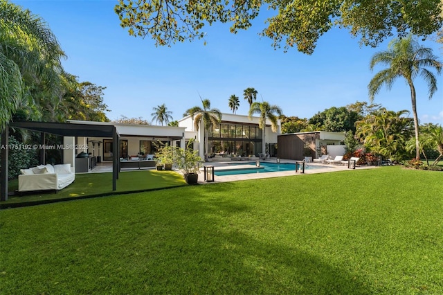 back of house with a yard, a patio area, and an outdoor pool