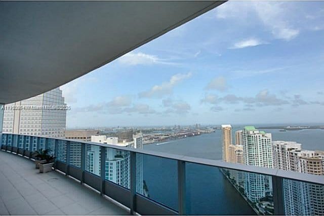 balcony with a water view and a city view