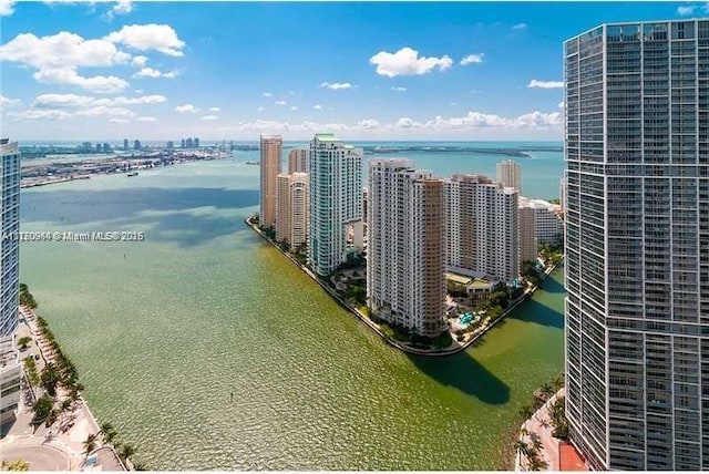 birds eye view of property with a water view and a city view