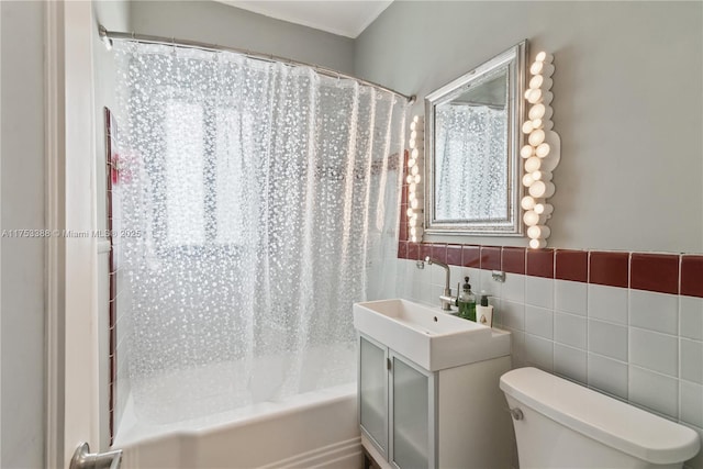 full bathroom with vanity, shower / tub combo with curtain, toilet, and tile walls
