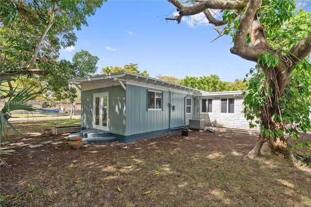 back of house featuring central air condition unit and french doors