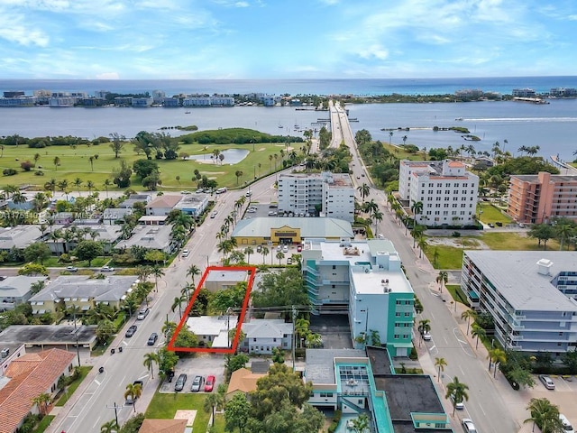 aerial view with a view of city, view of golf course, and a water view