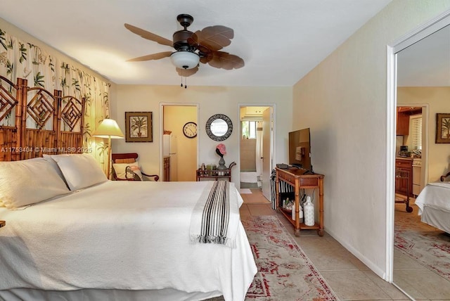 bedroom with light tile patterned flooring, ceiling fan, and ensuite bathroom