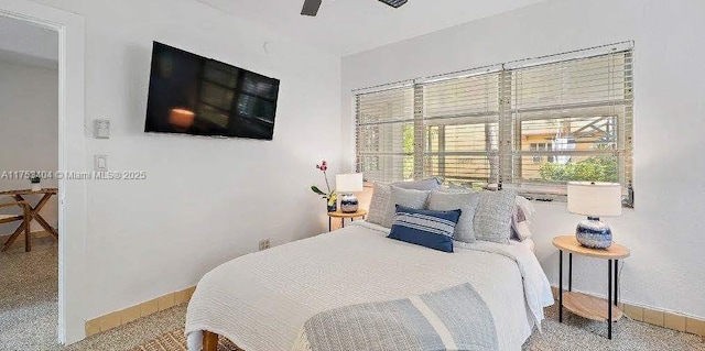 bedroom featuring a ceiling fan and baseboards