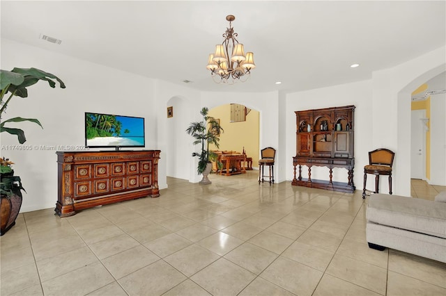 living area with arched walkways, light tile patterned floors, recessed lighting, visible vents, and a chandelier