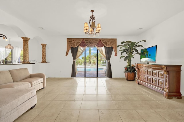 living room featuring a chandelier, ornate columns, visible vents, and tile patterned floors