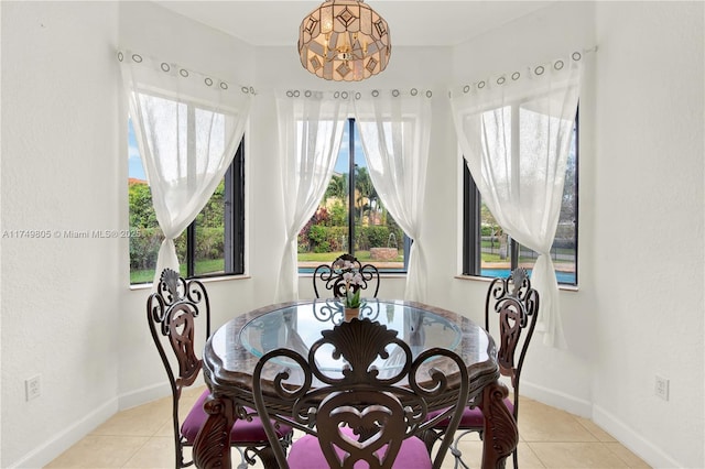 dining room with light tile patterned floors and baseboards