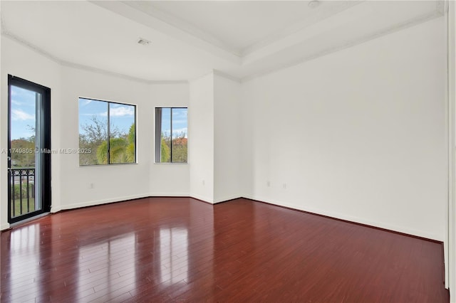 unfurnished room featuring baseboards and wood finished floors