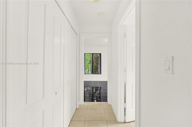 corridor with light tile patterned floors