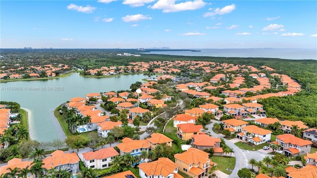 drone / aerial view with a water view and a residential view