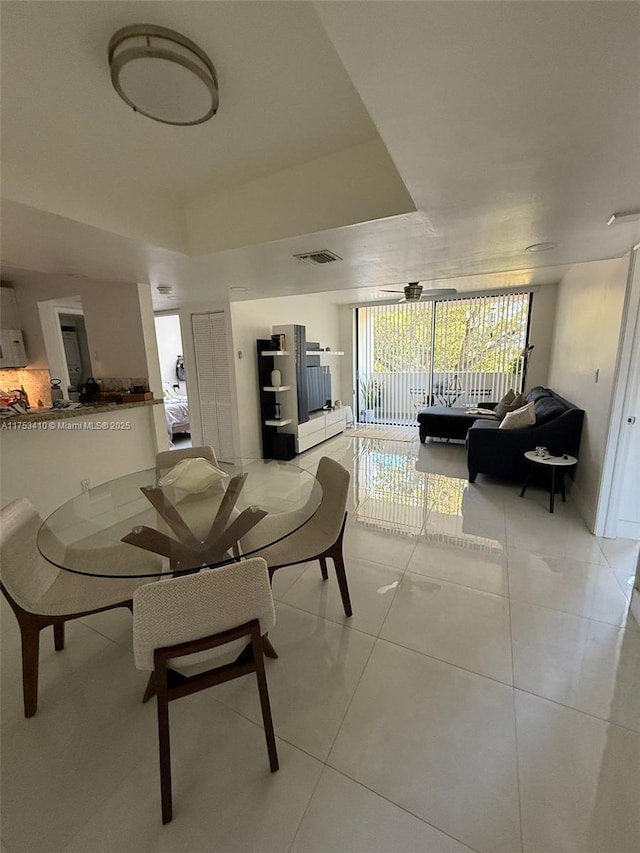 dining area with light tile patterned flooring and visible vents