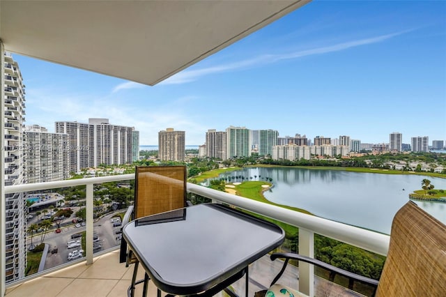 balcony featuring a water view and a city view