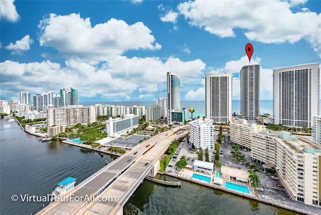 birds eye view of property with a city view and a water view