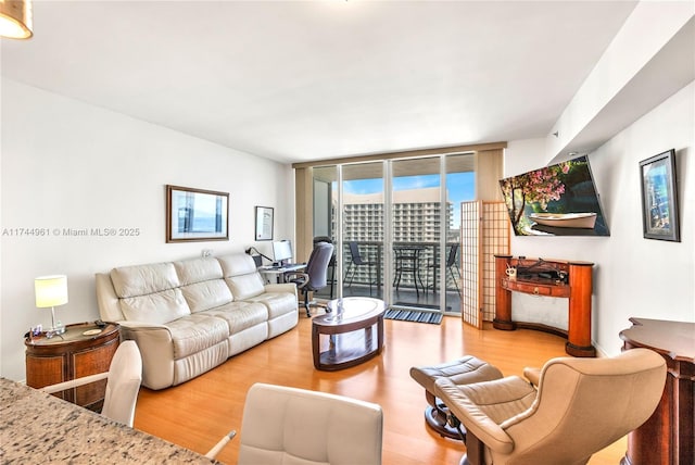 living room with floor to ceiling windows and wood finished floors