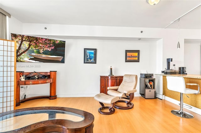 sitting room featuring baseboards and wood finished floors