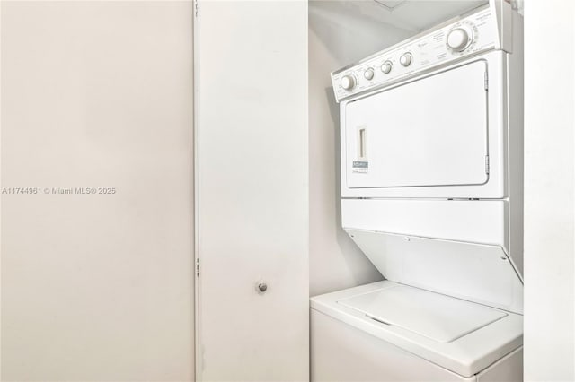 laundry room featuring laundry area and stacked washer / drying machine