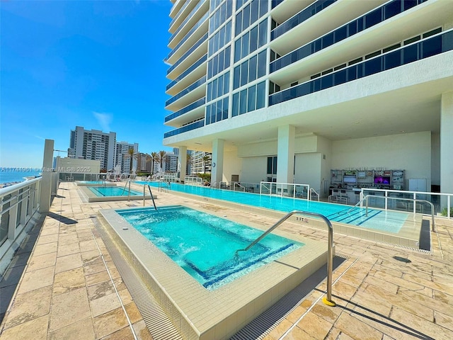 community pool featuring a community hot tub