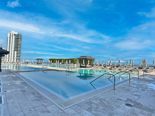 pool with a gazebo and a patio