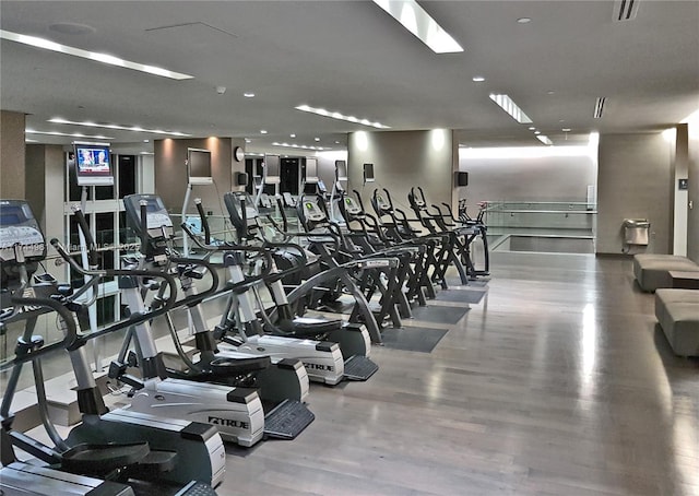 workout area with wood finished floors