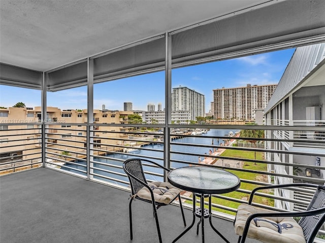 balcony with a water view and a city view