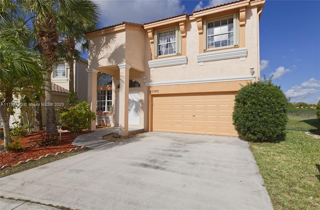 mediterranean / spanish house with a garage, concrete driveway, a tile roof, fence, and stucco siding