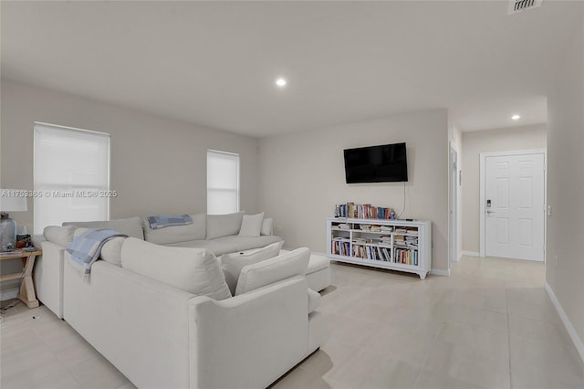 living area featuring light tile patterned floors, baseboards, and recessed lighting