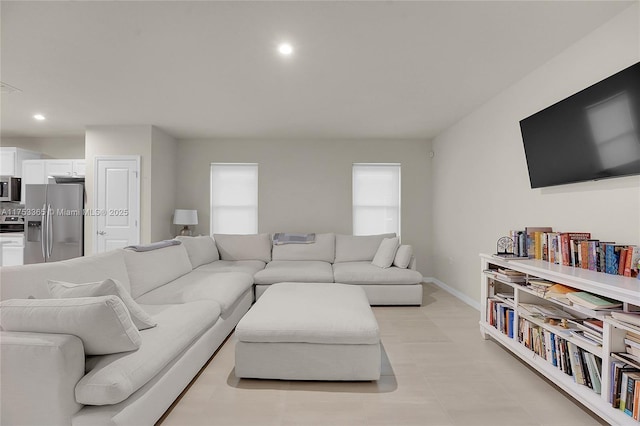 living area with baseboards and recessed lighting