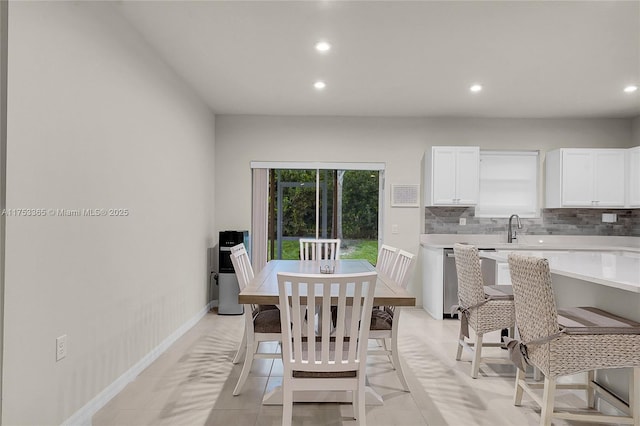 dining room with recessed lighting and baseboards