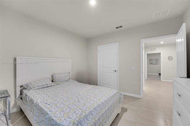 bedroom featuring light tile patterned flooring, visible vents, and baseboards