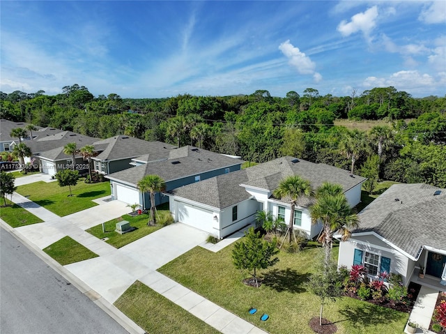 birds eye view of property with a view of trees