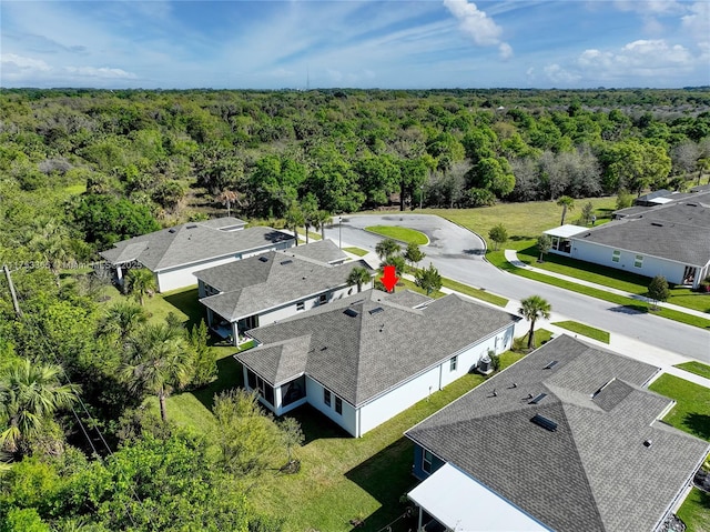 drone / aerial view featuring a wooded view