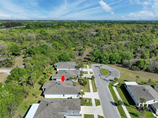 drone / aerial view featuring a forest view