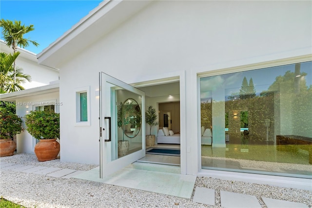 view of exterior entry with stucco siding