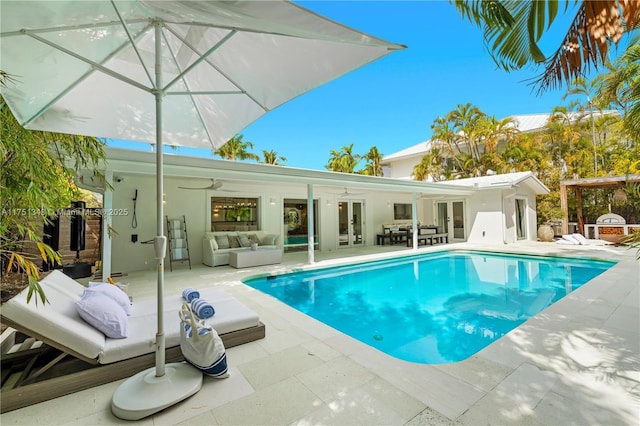 pool featuring french doors, a patio, and an outdoor living space