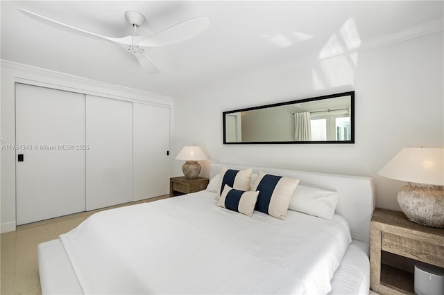 bedroom with a ceiling fan, a closet, and crown molding